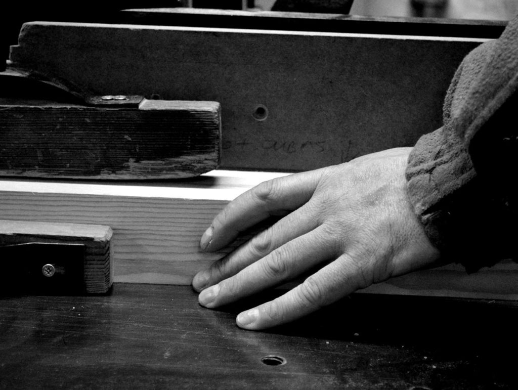 Our craftsmen working on a piece of timber