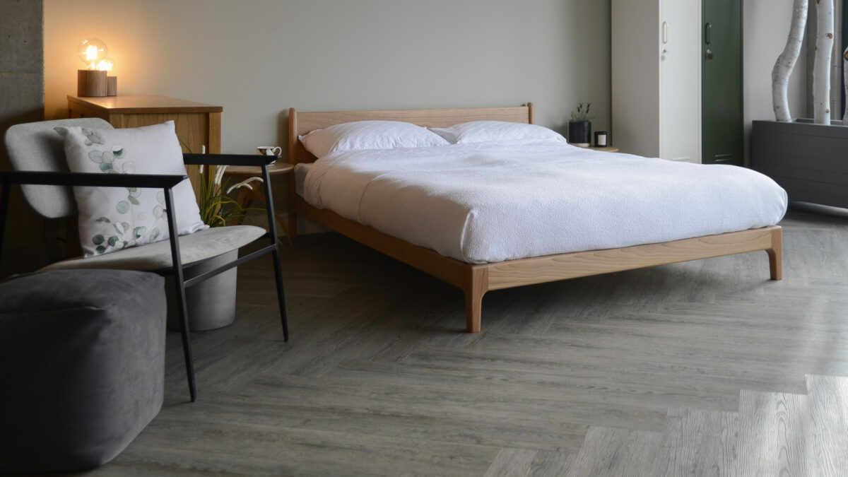 Spring bedroom look featuring the Pimlico bed, a low midcentury style wooden bed, here in cherry