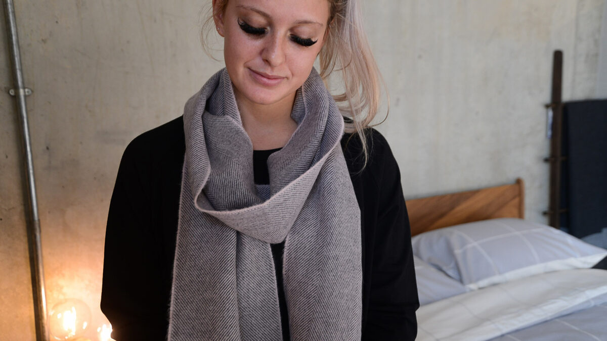 herringbone weave merino wool scarf in grey and pink shown worn