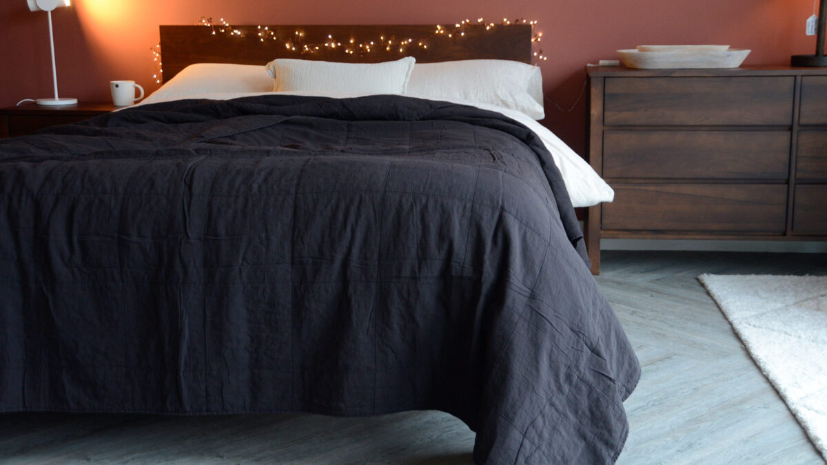 Plain Soft Bedspread Black Draped on Smoked Walnut Malabar