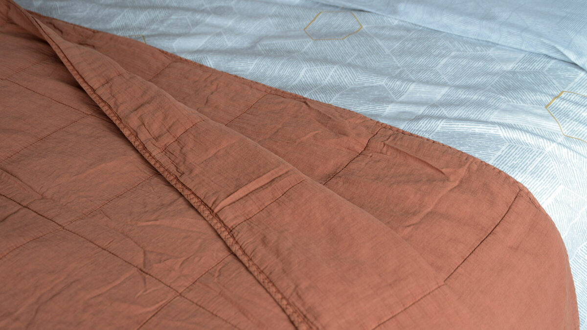 soft quilted cotton bedspread in terracotta colour