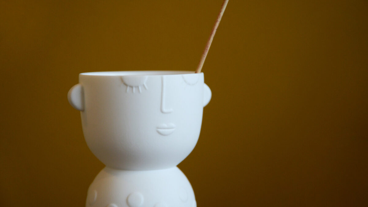 matt white porcelain vase or candle holder with face