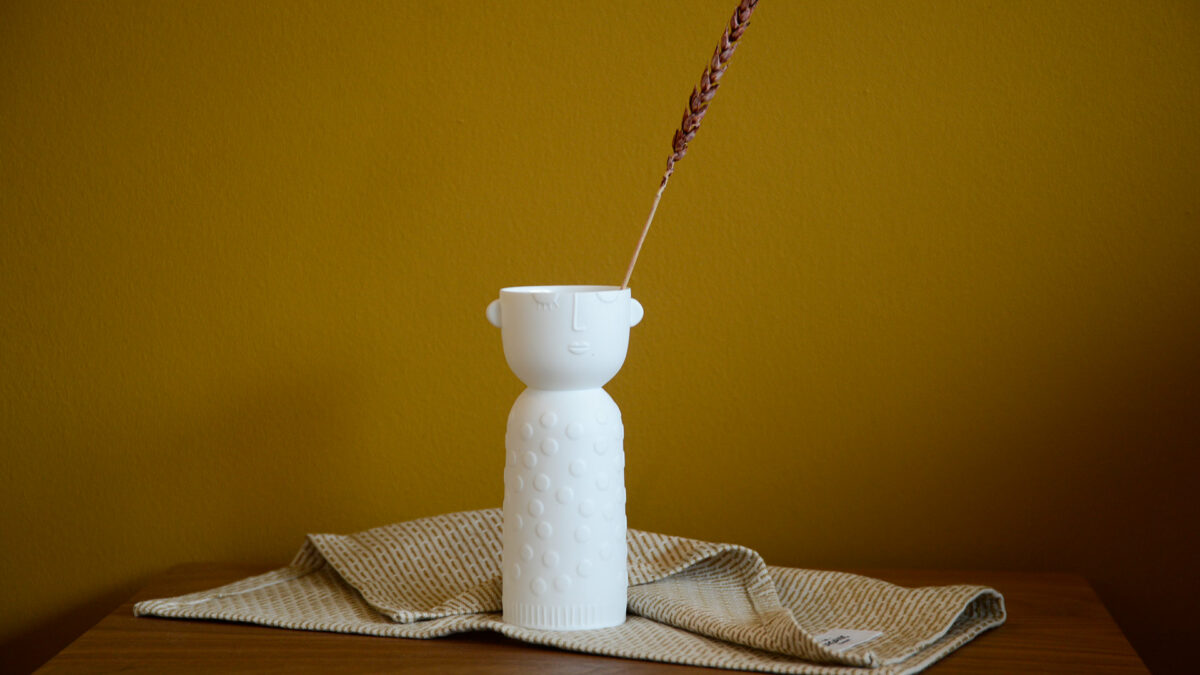 white porcelain vase or candle holder with face