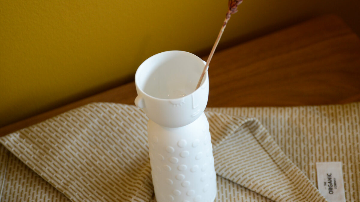 white porcelain vase or candle holder with face