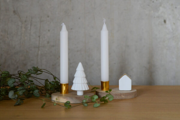 small candle holders with a wooden base and porcelain Christmas tree or house with gold roof