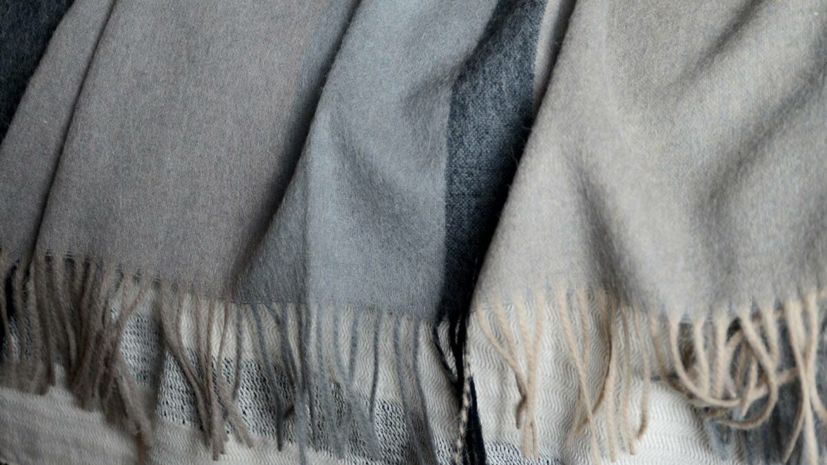Recycled Alpaca Wool Throw in grey and beige colours shown close up
