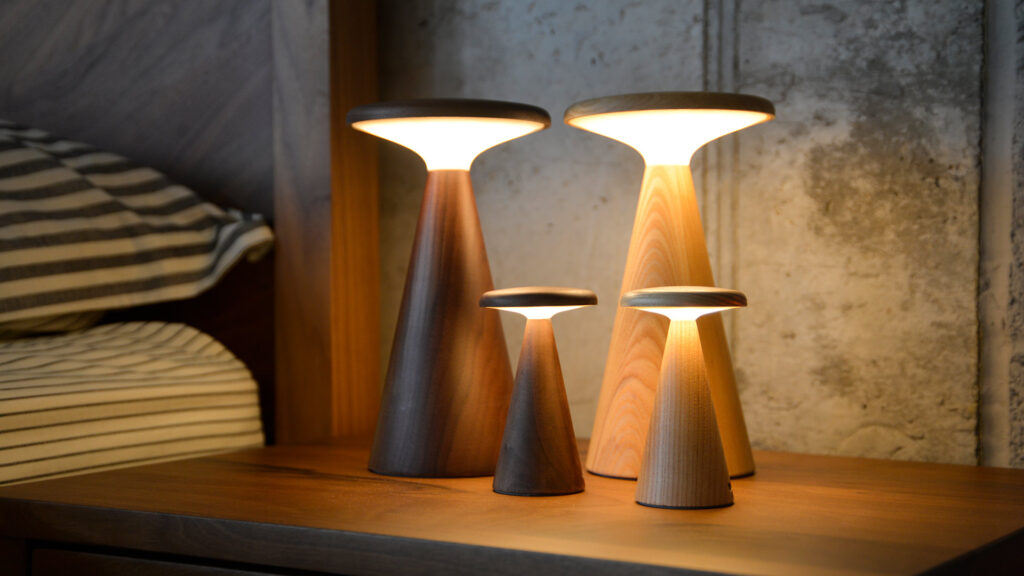 4 retro wooden table lamps. all lit in warm light.
