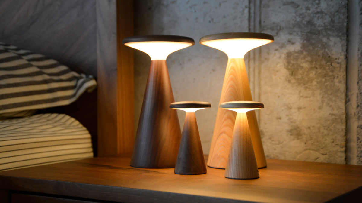 4 retro wooden table lamps. all lit in warm light.