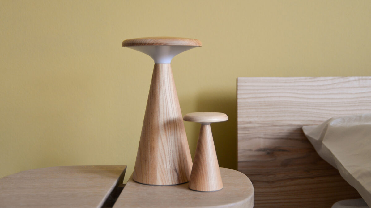 2 Oak table lamps, one large and one small, switched off.