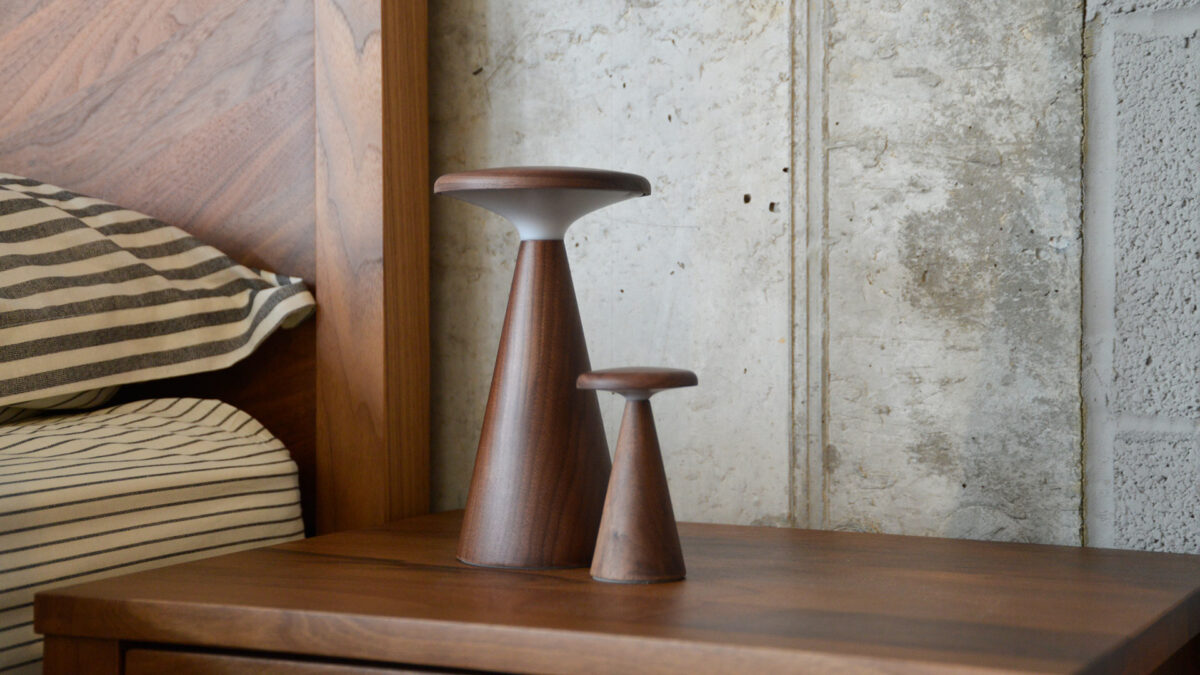 Retro wooden table lamps, one large, one small, both switched off.
