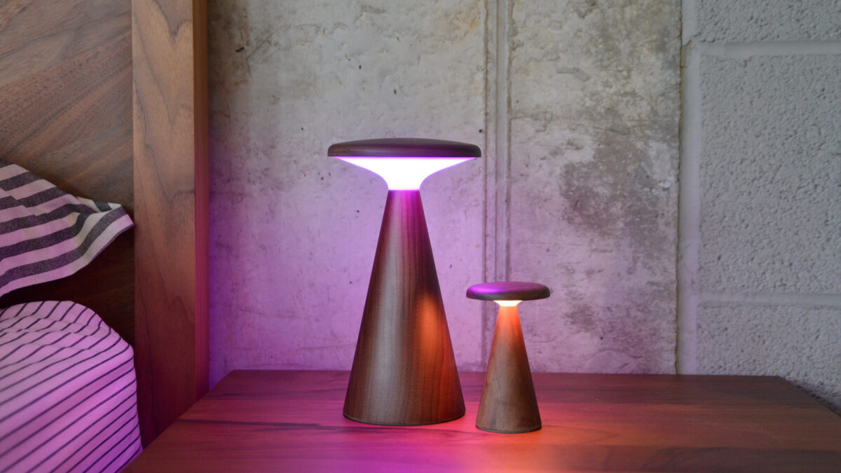 Retro wooden table lamps, one large, one small showing purple light.