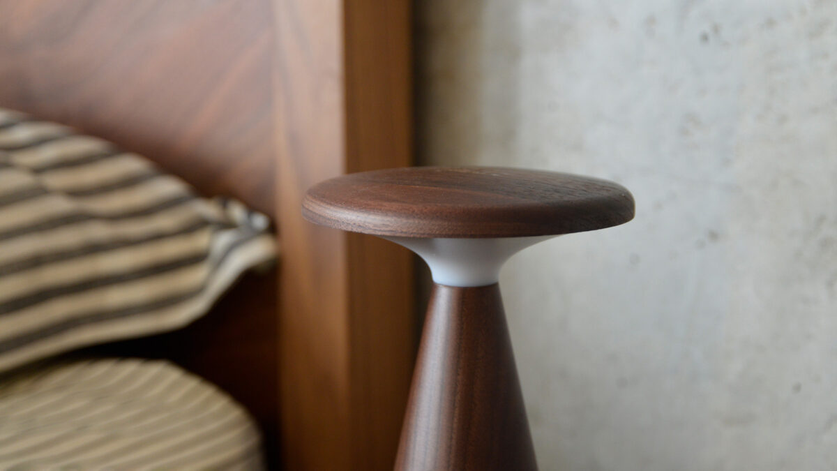 close up of the circular top of a retro walnut table lamp.