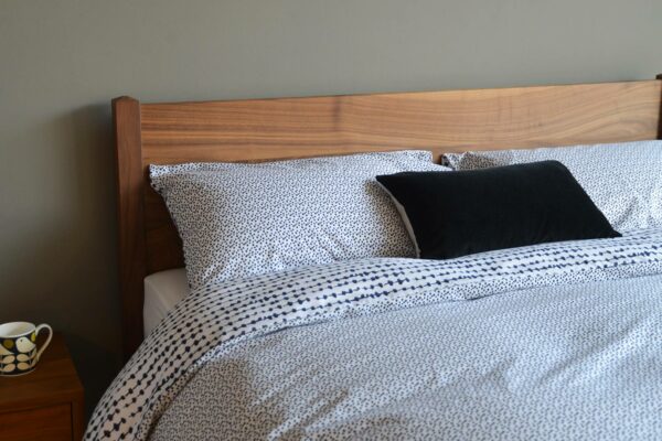 monochrome abstract print duvet cover set shown on our walnut wood Cochin bed