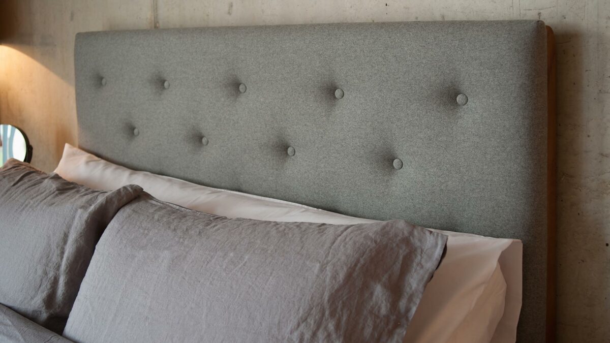 Skye wooden bed tall buttoned headboard close-up