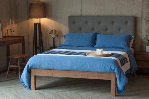 Classic taller wooden Skye bed with tall buttoned headboard & blue linen bedding