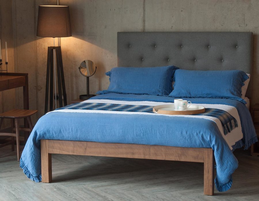 Skye bed with tall buttoned headboard blue linen bedding