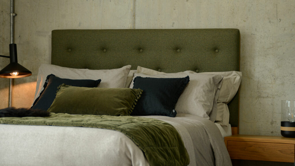 The tall upholstered and buttoned Skye bed headboard