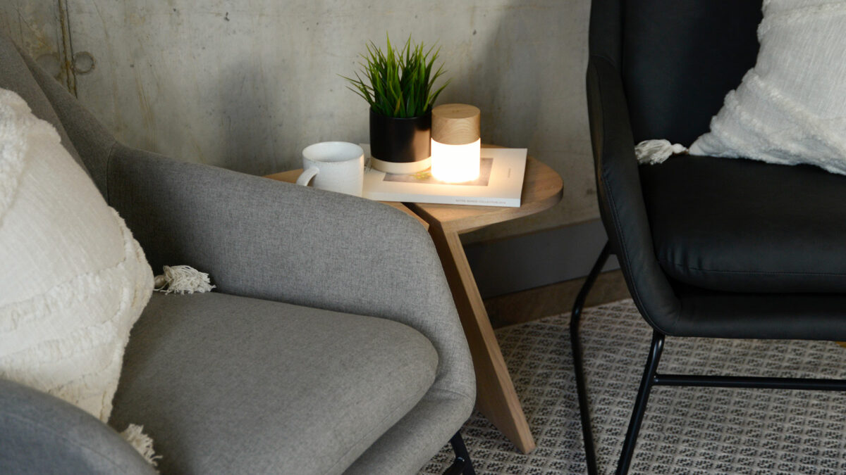 light grey and charcoal grey armchairs with a black painted sled bases