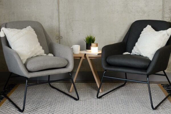 light grey and charcoal grey armchairs with a black painted sled bases