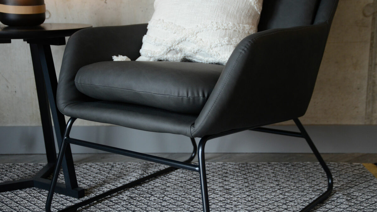 charcoal grey armchair with a black painted sled base