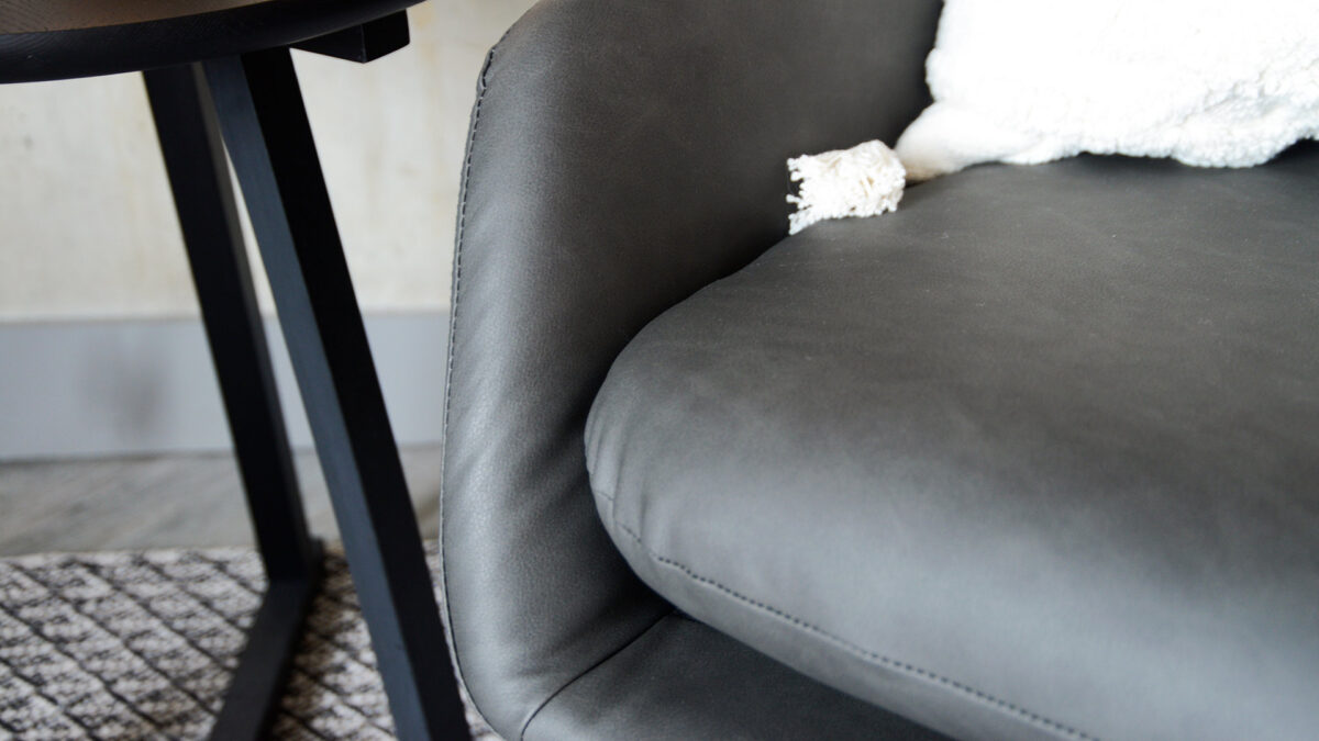 charcoal grey armchair with a black painted sled base