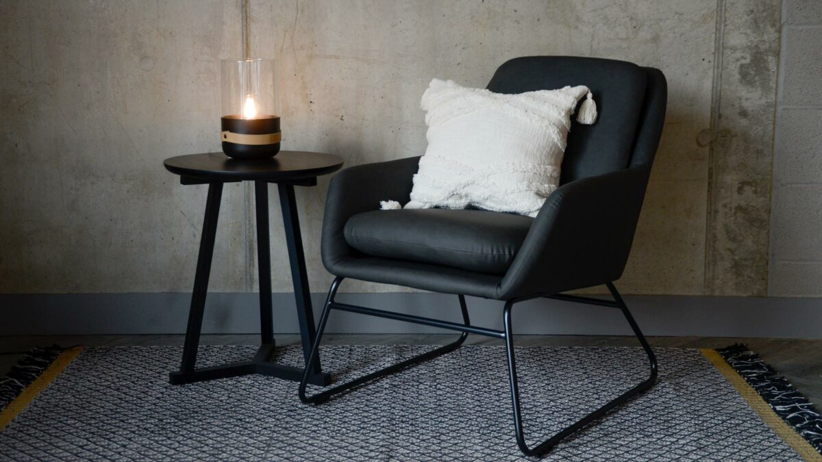 charcoal grey armchair with a black painted sled base