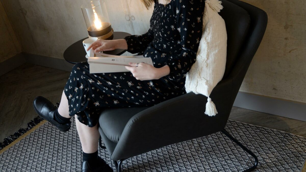 charcoal grey armchair with a black painted sled base