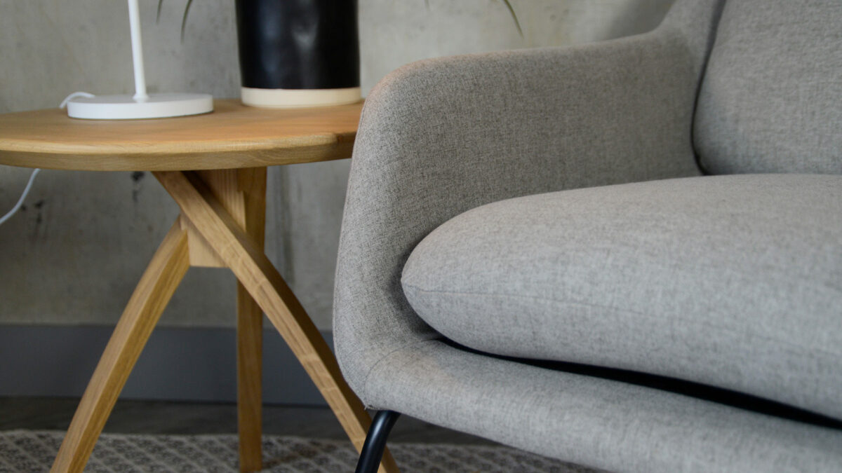 grey armchair with a black painted sled base