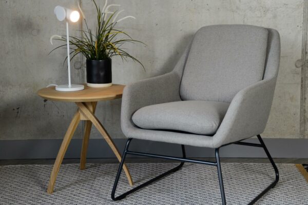 grey armchair with a black painted sled base