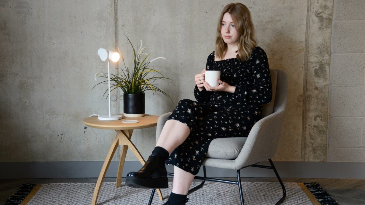 grey armchair with a black painted sled base