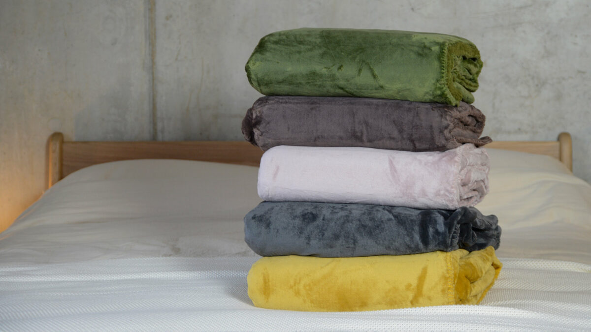 soft and cosy microfibre fleece throws in a range of colours and shown stacked