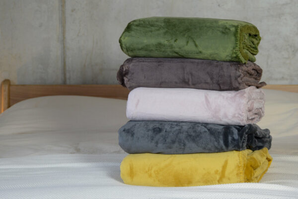 soft and cosy microfibre fleece throws in a range of colours and shown stacked