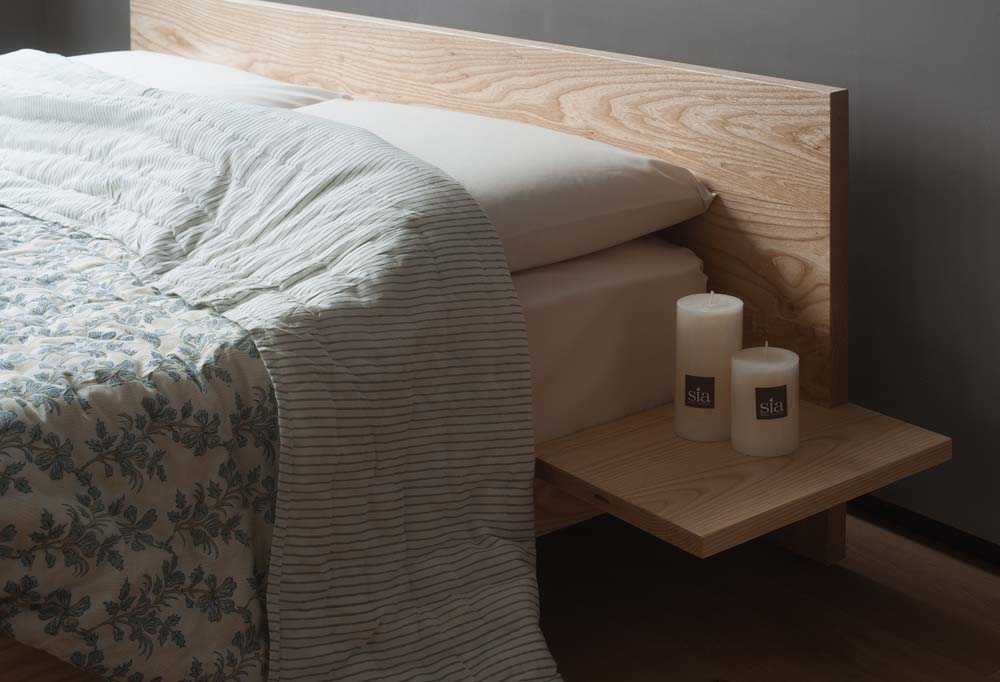 A closer view of our ash wood Kulu Japanese style bed where the headboard and optional side table join.