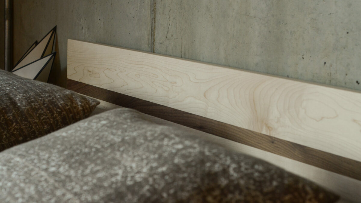 A closer view of the Tibet wooden bed headboard in Maple with a Walnut stripe