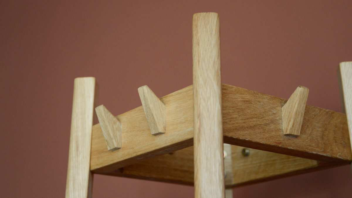 tower coat stand - close up of hooks and top pillars of stand.