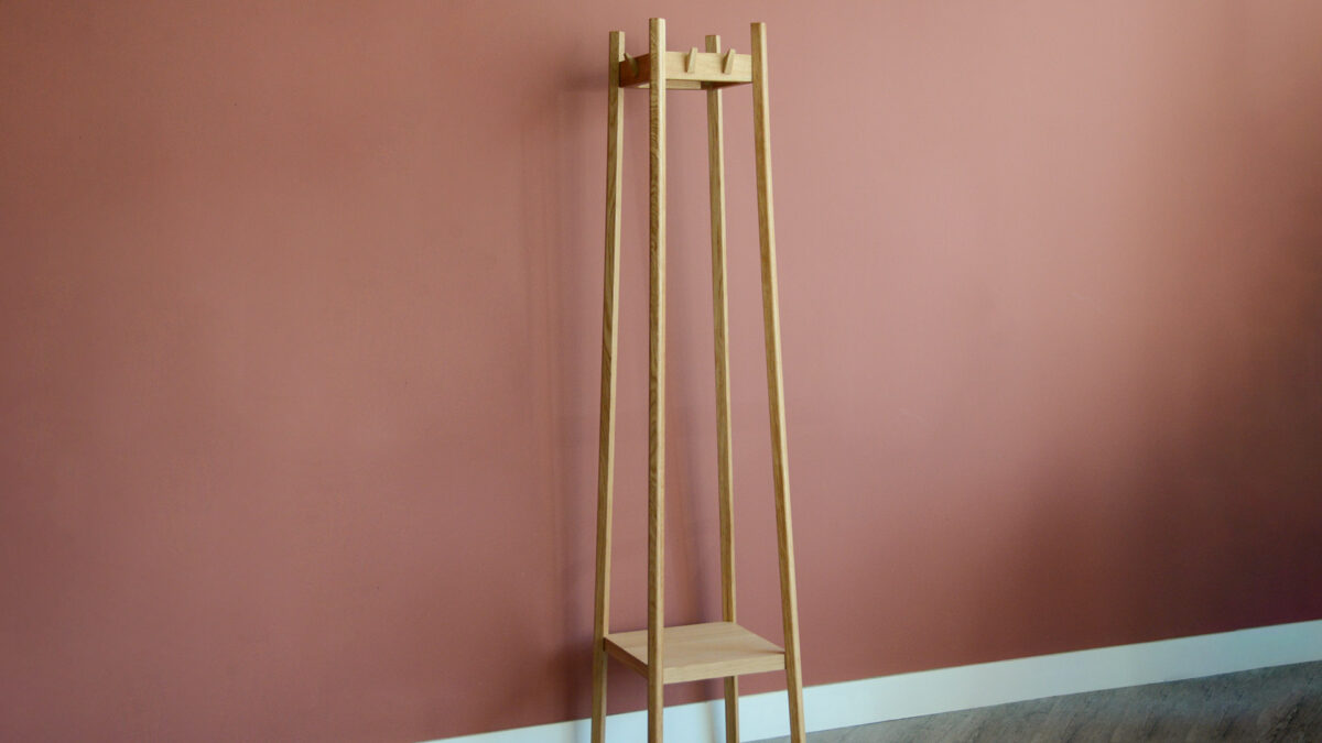 Full view of tall coat stand with bottom shelf.
