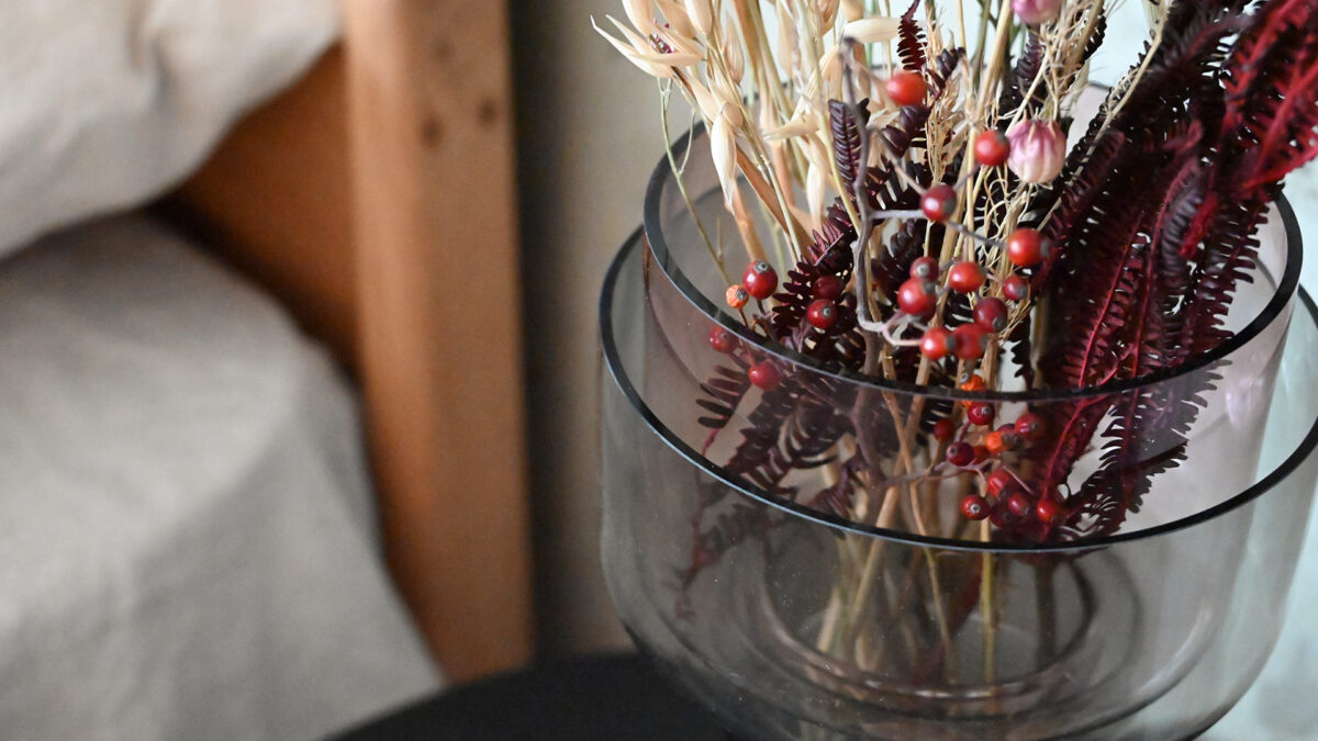 close up of bouquet in two tone glass vase.