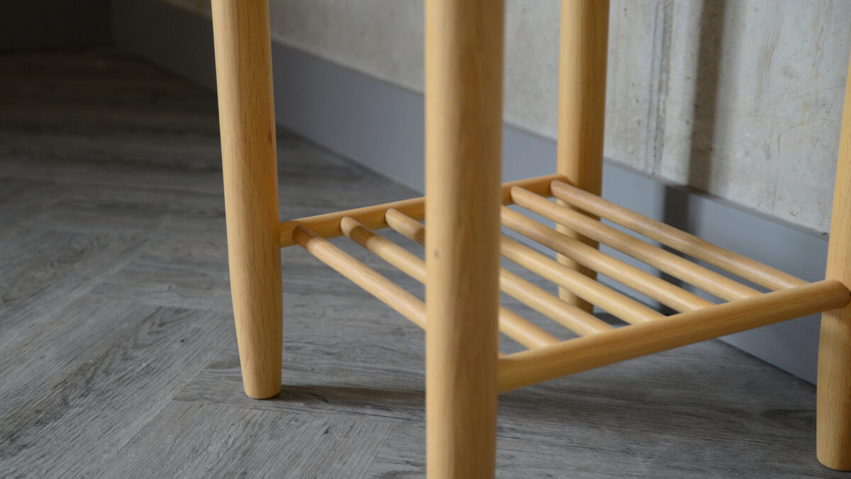 a close-up of the circular bedside table lower shelf