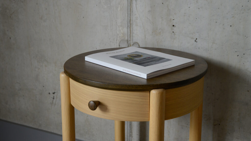 circular bedside table with drawer and lower shelf