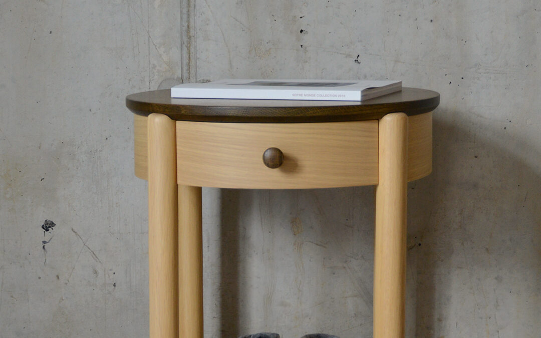 circular bedside table with drawer and lower shelf