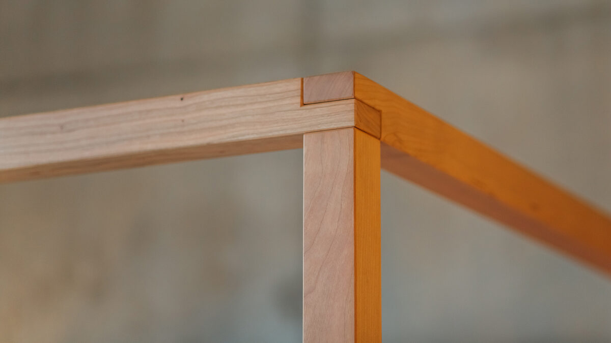 Upholstered cherry 4 poster close up of top post