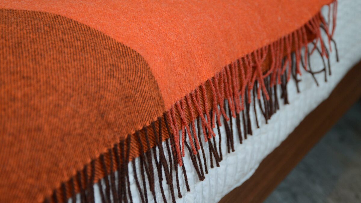 100% pure wool colour block throw in orange with brown tones