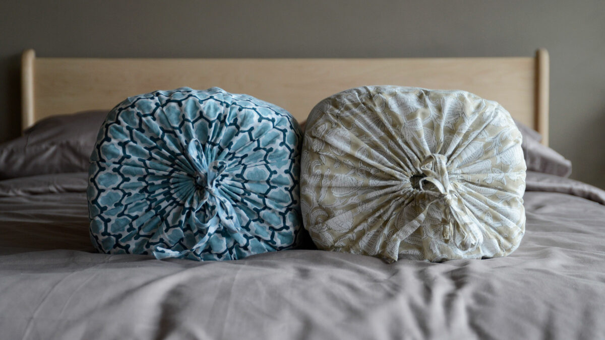 Reversible block printed quilts in 2 colour options come in a drawstring bag