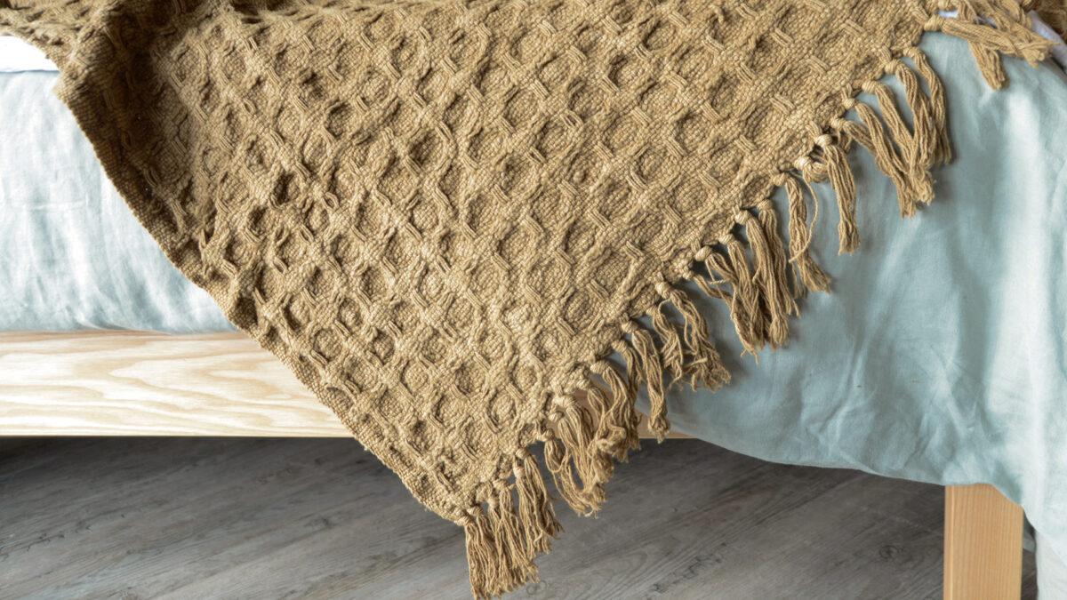 textured weave fringe edged throw in a caramel colour