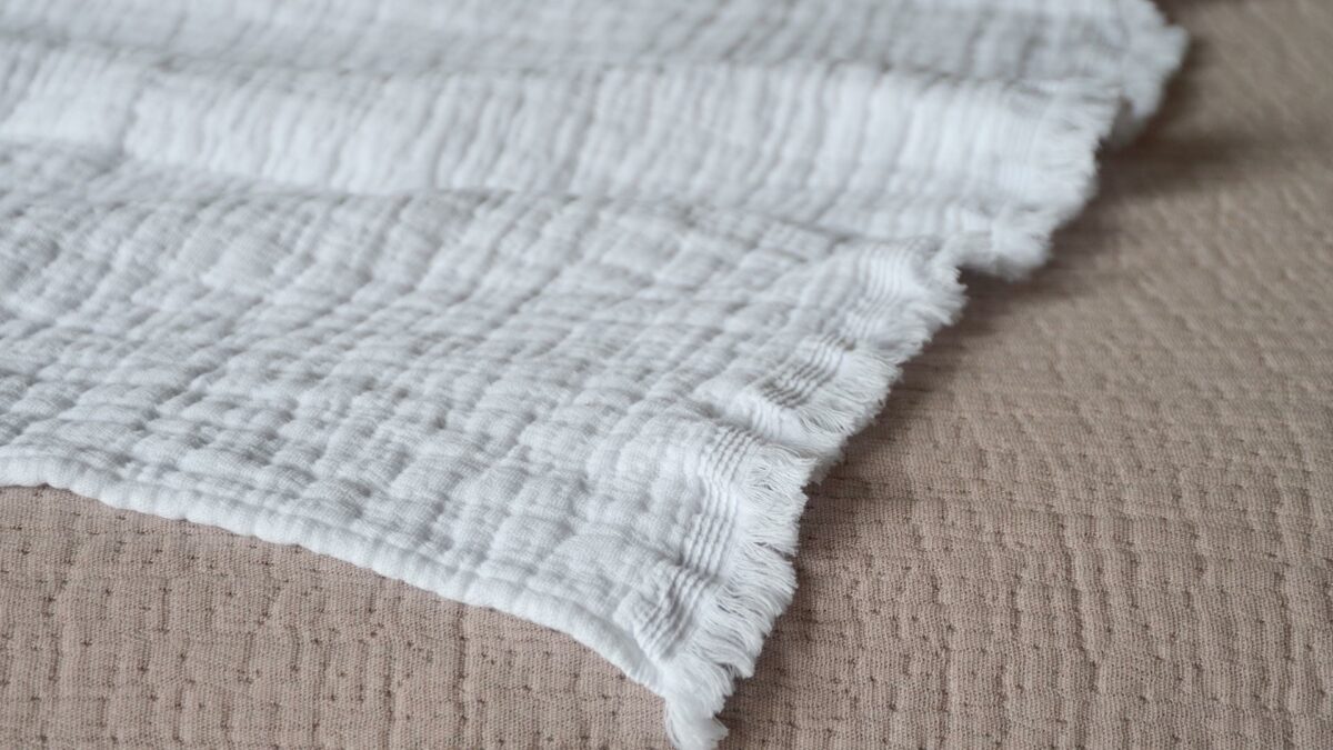 Pure cotton crinkled effect white throw up close to show fringed edge