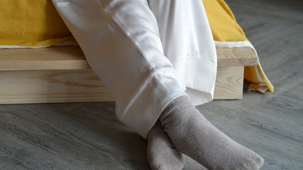 close up of white satin pyjama bottoms.