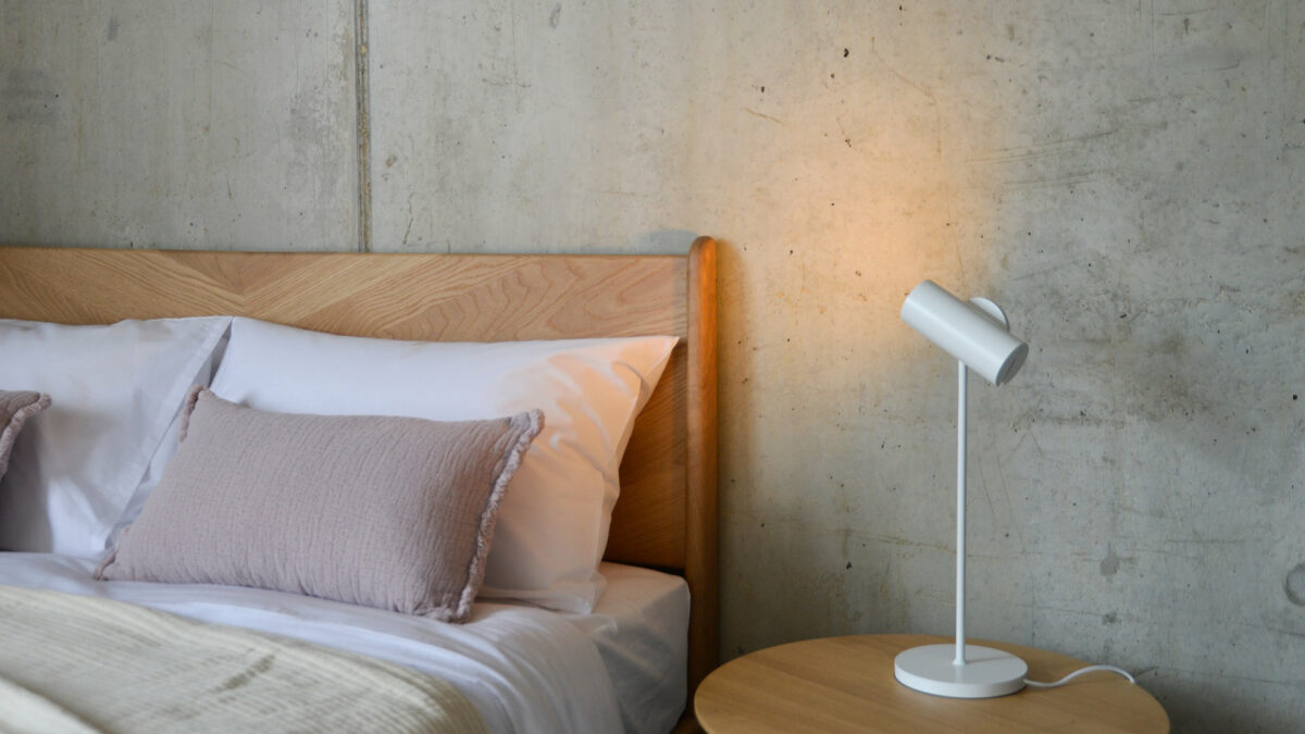 adjustable spotlight in white used as a bedside lamp