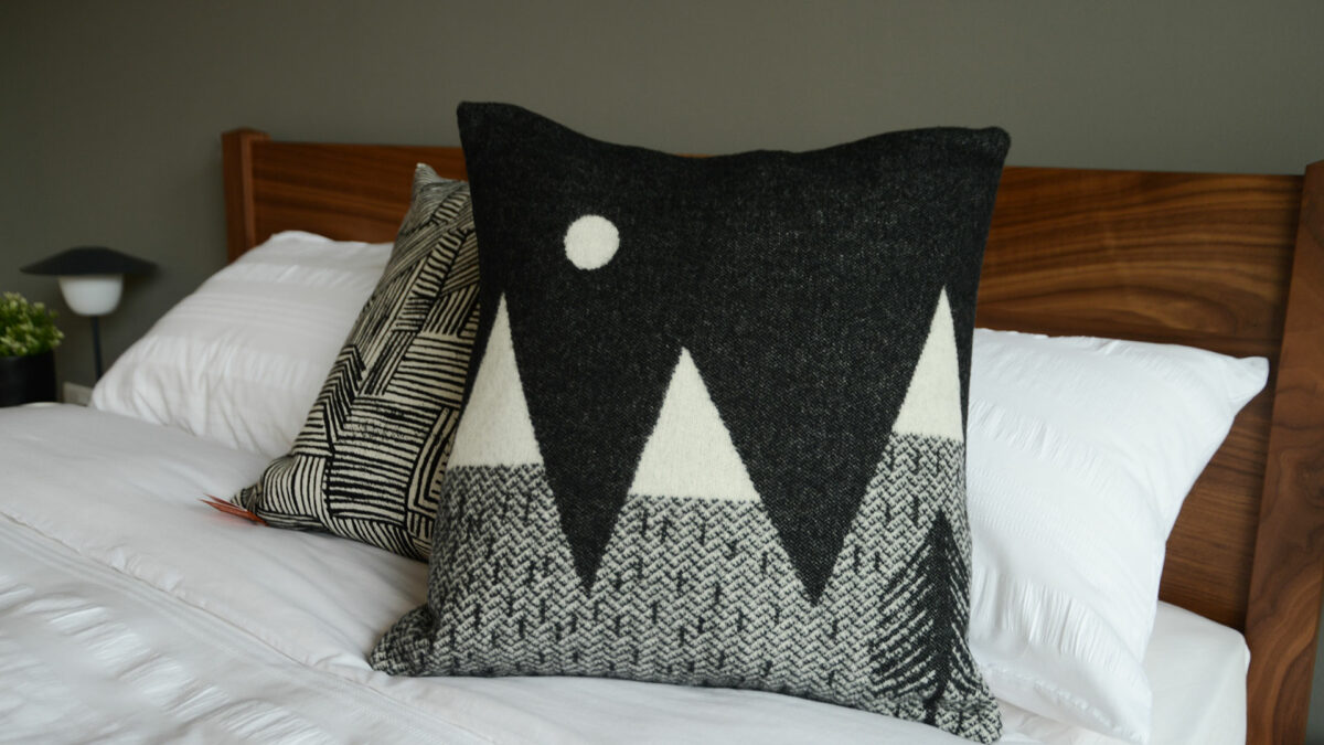 Donna Wilson small knitted mountain scene cushion in black and white