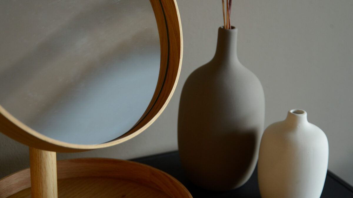 Wireworks oak mirror close up detail on frame with vases in background