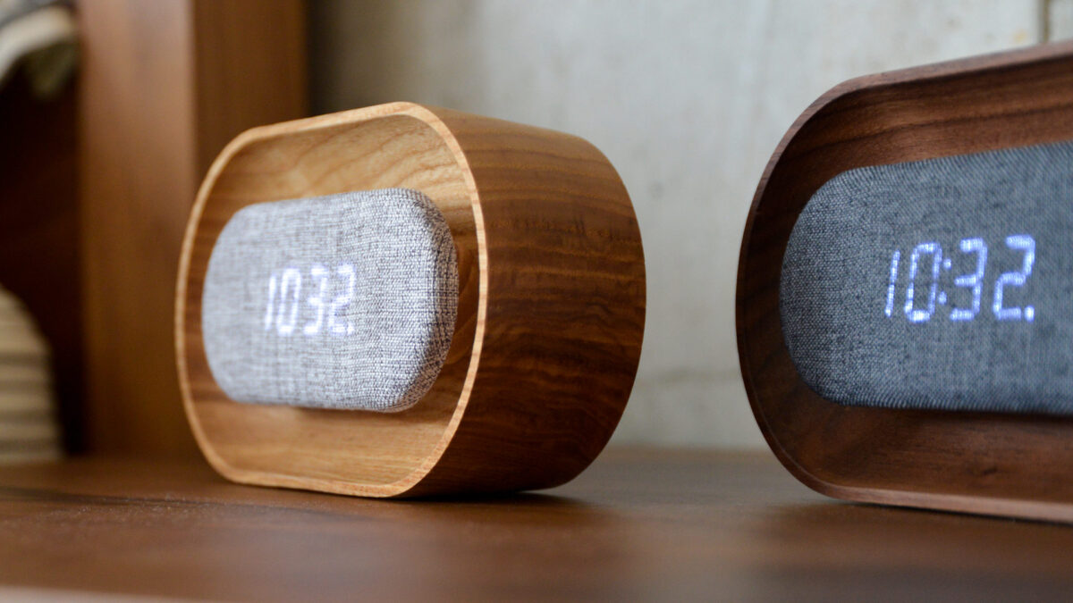 close up of an oak and a walnut digital alarm clock.